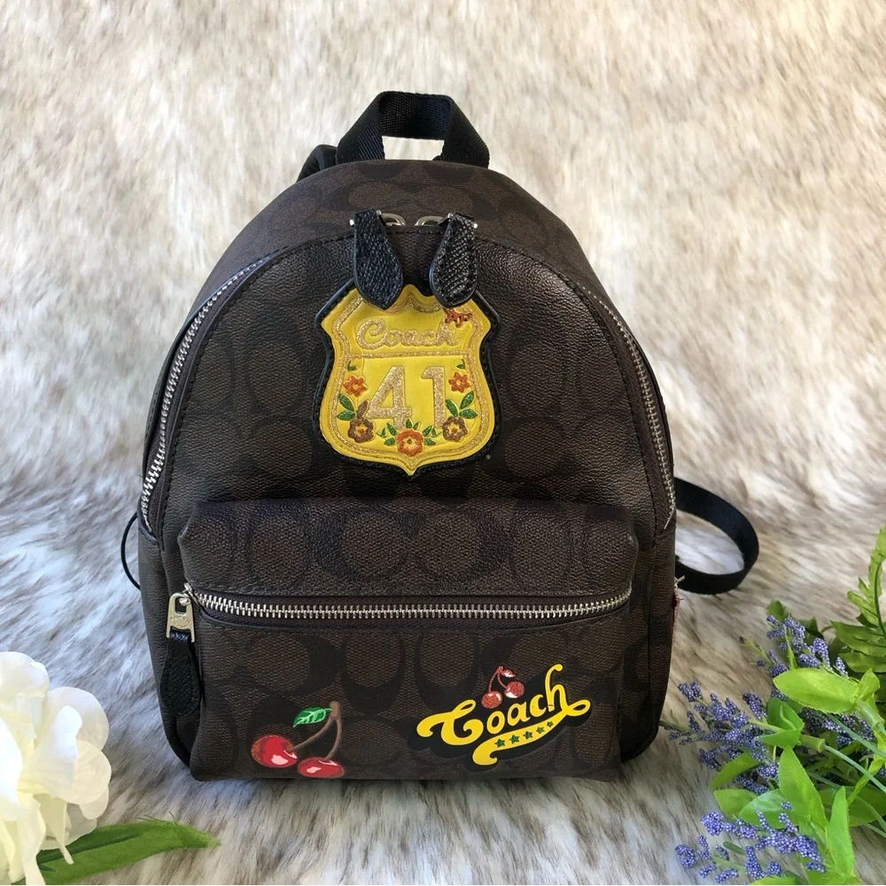 coach charlie signature backpack Pebble Leather (Khaki/Black), Large Clothing, Shoes & Accessories Signature coated canvas and smooth leather Inside zip cell phone and multifunction pockets Laptop compartment with zip closure Zip closure recycled polyester lining Top handle with 3 drop Outside zip pocket Luggage sleeve Adjustable shoulder straps Fits a 16 laptop 11 3/4 (L) x 16 1/2 (H) x 6 (W) Style No. Coach Charlie Signature Backpack |